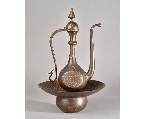 A Qajar gold-damascened ewer and basin, 19th century, the ewer on spreading foot, the bulbous body damascened each side with 