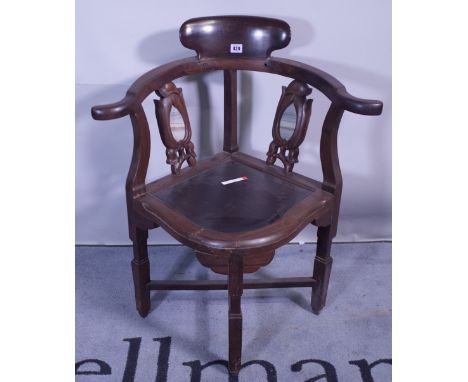 A 20th century Chinese hardwood corner chair with inset marble panelled back.  Provenance; property from the late Sir David T