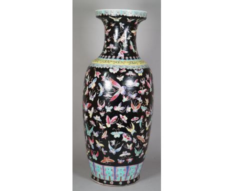 A Chinese famille-rose black-ground baluster vase, 20th century, printed and coloured  with insects beneath ruyi-head borders