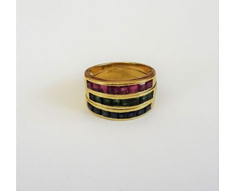 A gold, sapphire, emerald and ruby ring, mounted with a row of square cut sapphires, a row of square cut emeralds and with a 