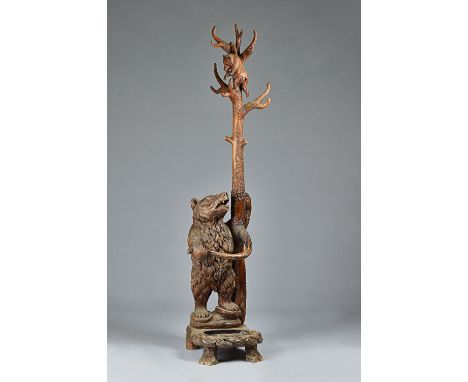 A Black Forest carved pine/linden wood stick and coat stand in the form of a bear and her cub, 42cm wide x 200cm high.Illustr