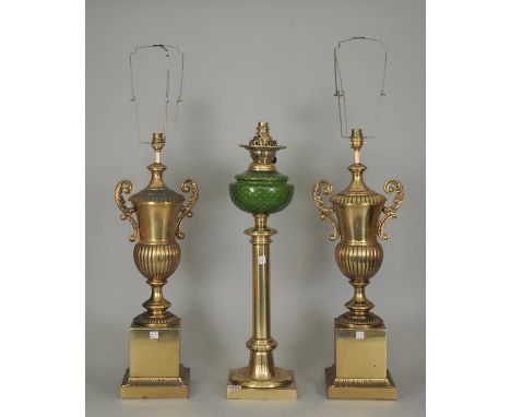 A brass oil lamp with green glass reservoir of column form (converted) and a pair of Victorian style gilt metal table lamps o