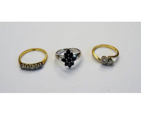 A gold and platinum, diamond set two stone ring, in a crossover design, detailed 18 CT PLAT, a gold and diamond set five ston