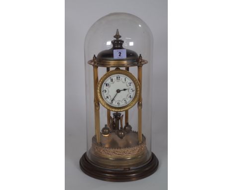 A Torsion anniversary clock, within a glass dome case, 45cm high. 