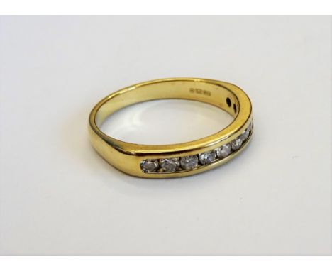 A 9ct gold and diamond half hoop eternity ring, channel set with a row of eleven circular cut diamonds, ring size L.