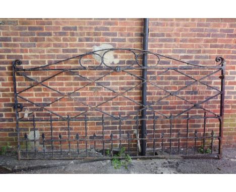 A large black painted wrought iron estate gate, with arch top and Tudor Rose mounts, 306cm wide x 165cm high. 