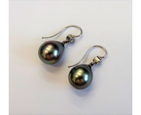 A pair of diamond and grey tinted cultured pearl earrings, each mounted with a grey tinted cultured pearl to the drop and col