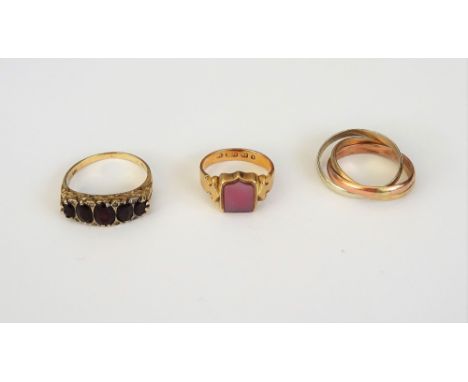 A 9ct three colour gold Russian style wedding ring, ring size S and a half, weight 5.2 gms, a 9ct gold and garnet set five st