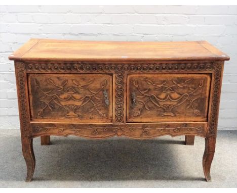 An 18th century French walnut commode, with pair of carved doors, on cabriole supports, 125cm wide x 81cm high. 