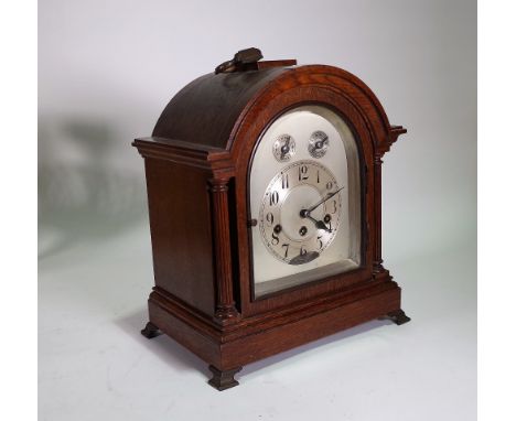 A 1920s oak cased eight day mantel clock with German 'Junghans' movement, 37cm high, (key and pendulum). 