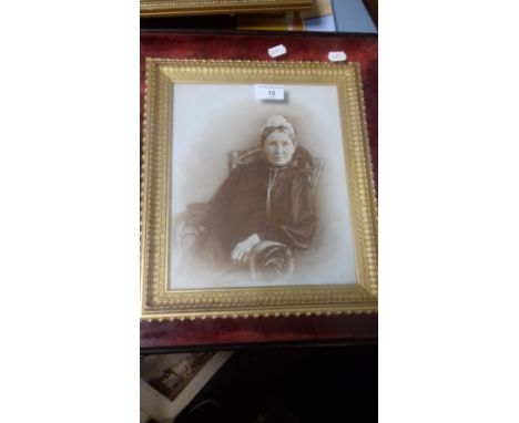 A FRAMED AND GLAZED PORTRAIT OF AN ELDERLY LADY SAT IN A ROCKING CHAIR