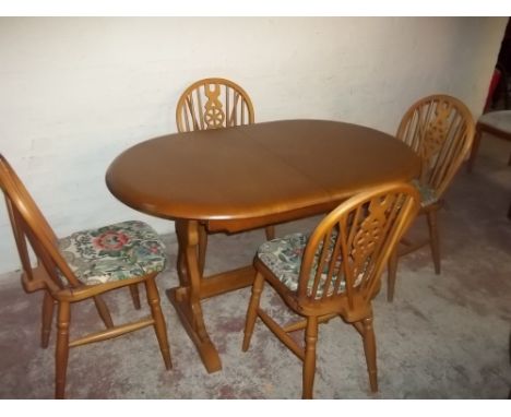 A LIGHT OAK DINING ROOM TABLE AND FOUR WHEELBACK CHAIRS