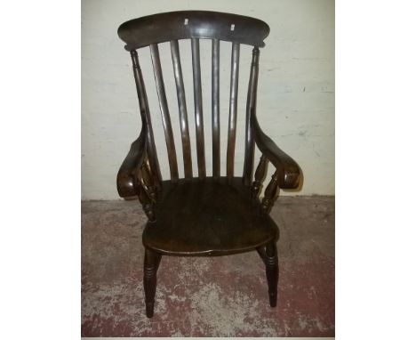 AN OAK STICK BACK WINDSOR ARMCHAIR