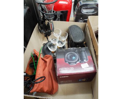 A pair of binoculars, a Casio camera, a small Lumix camera and an unusual optic with five glasses