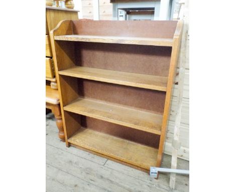 A 1930's oak fixed shelf bookcase 