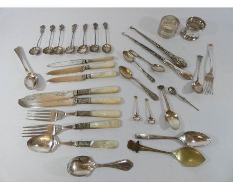 A collection of hallmarked silver and silver plate to include white metal spoons, a pair of silver napkin rings, button hooks