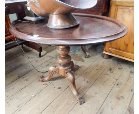 An oval mahogany tray top table on a Victorian walnut pillar and tripod base 