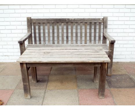 A teak garden bench seat with matching slatted coffee table 