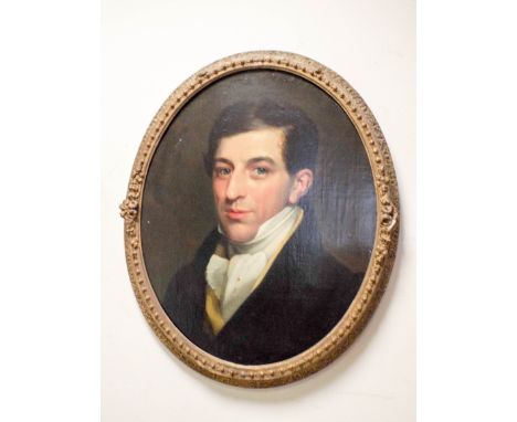 An early 19th Century oil on canvas portrait of a Regency gentleman in an oval gilt frame      Condition Report;The portrait 