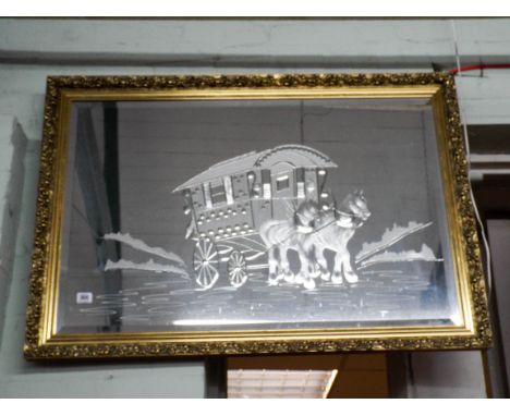 A large gilt framed over mantel mirror with etched panel depicting gypsy caravan 