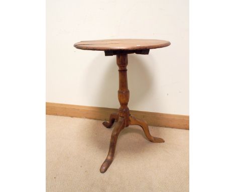 A circular Victorian pine occasional table on pillar and tripod base 