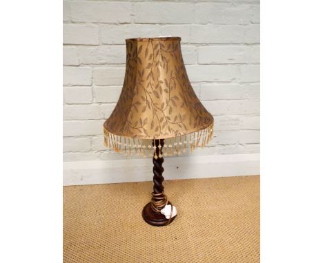 An oak, barley twist column electric table lamp with gold patterned fringed shade  