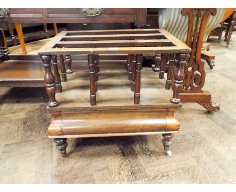 A 19th century rosewood music Canterbury raised on ceramic casters 