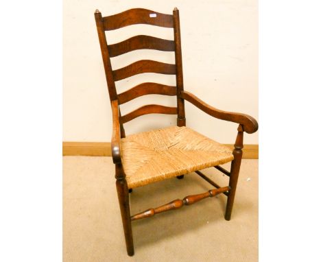 A Lancashire style oak ladder backed elbow chair with rushed seat (shaky) 