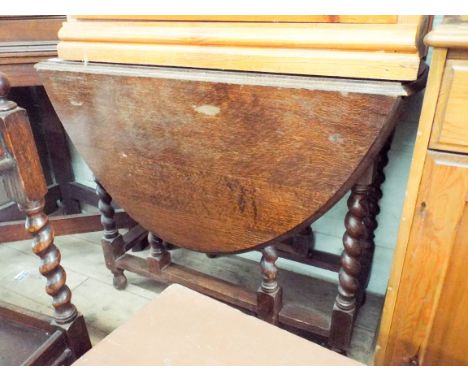 An oval oak gate legged table on barley twist legs, 3' wide 