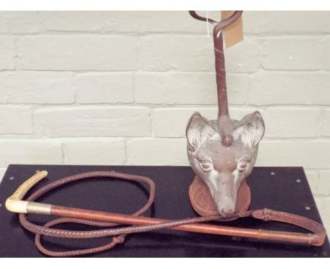 Victorian brass fox mask door stop and a leather hunting whip