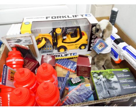 A large box containing a water pump, meerkat toy, water bottles, Wii games, pencils, radio controlled fork lift etc  