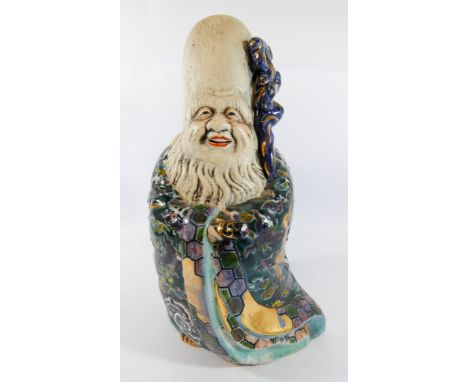 A Japanese model of Kutani model of a sage with a polychrome enameled cloak, 27cm tall