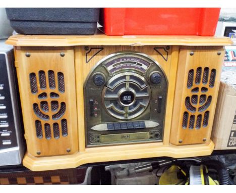 A radio cassette player with record deck in an old style wooden case 