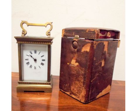 A late Victorian brass carriage clock with leather travelling case 