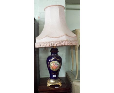 A decorative sevres style picture panel table lamp with pink fringed shade 