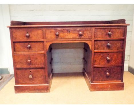 A Victorian mahogany knee hole desk or dressing table with tray top, fitted with nine drawers, 4' wide 