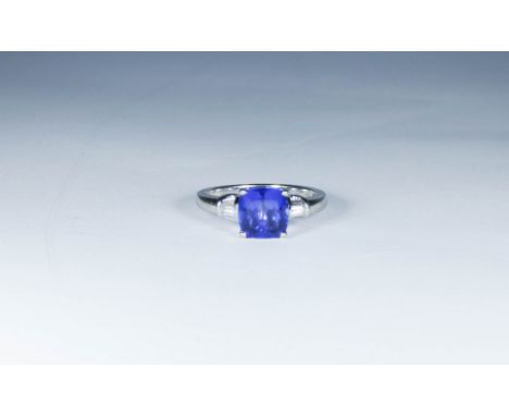 Tanzanite and diamond ring, set with a cushion cut tanzanite in four claw art deco style setting with baguette cut diamonds t