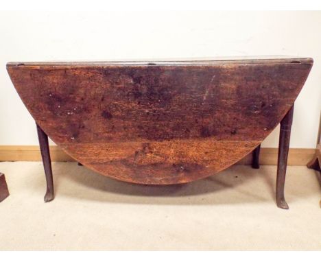 A 17th Century oval oak gate legged style table with four cabriole style legs on pad feet, table fitted with one drawer, when