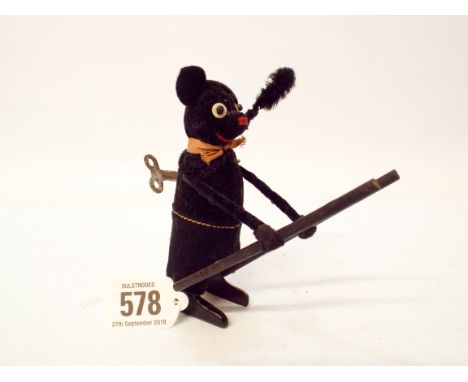 A Schuco, wind-up mechanical toy, of a black bear chimney sweep with ladder, complete with its key   Minor wear to felt, gene