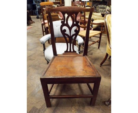 An antique oak Chippendale design hall chair with wood panel seat 