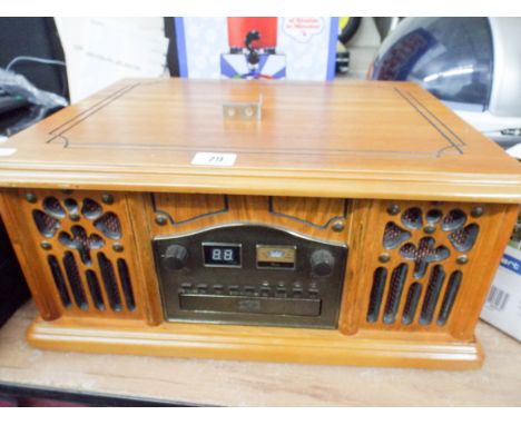 A radio cassette player with record deck in an old style wooden case 