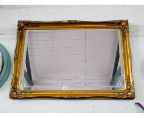 A large bevel edged gilt framed over mantel mirror 