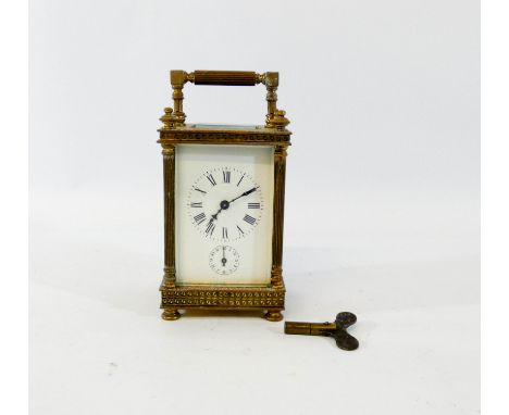 A 19th century brass carriage clock in a classically designed case with columns, alarm mechanism and key, height including ha