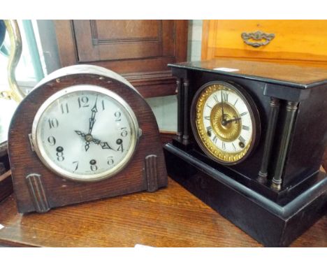 A black slate mantel clock and a 1930's oak dome top mantel clock 