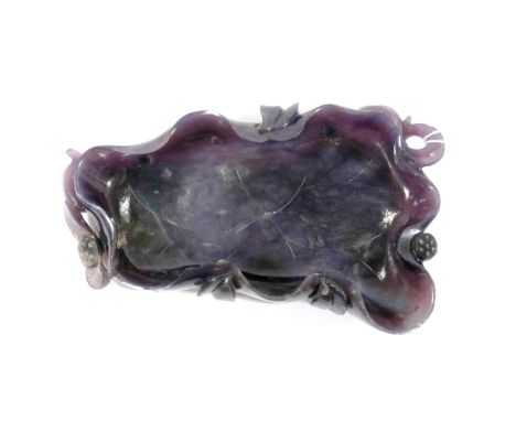 A Chinese purple jade leaf brush washer modelled as lotus leaf, 18cms across      It has at some point had feet attached to t