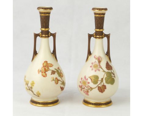 A pair of 19th Century Royal Worcester twin handled vasesEach having hand-painted and gilt floral decoration on an ivory grou