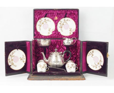 A Victorian silver travelling tea serviceCased, the silver of circular form, profusely engraved with scroll detail, comprisin