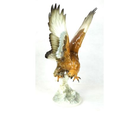 A large Lorenz Hutschenreuther German model of an eagleIn flight, raised on naturalistic form support, height 44cm, factory m