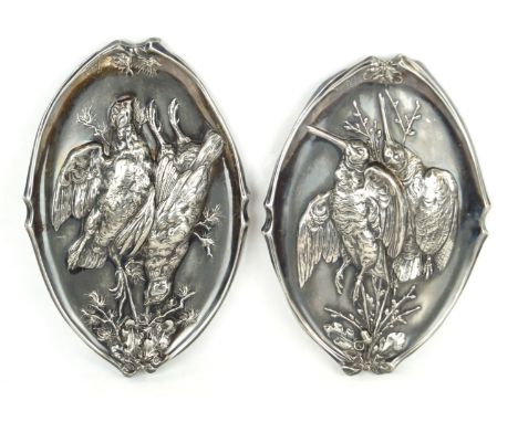 A pair of silver-plated hunting plaquesOf oval form, each panel embossed with games birds amongst acorns and other foliage, b