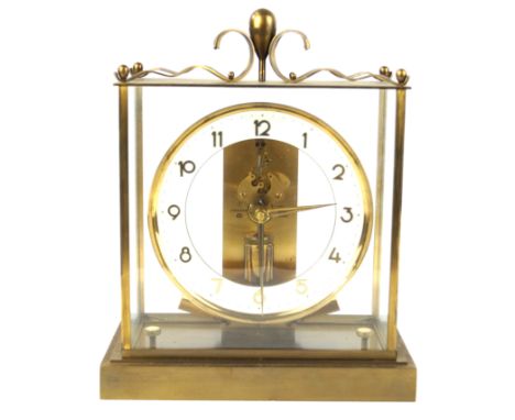 A Junghans ATO Anticlimactic Electric mantle clock Having brass framed case, raised on block support, height 27cm